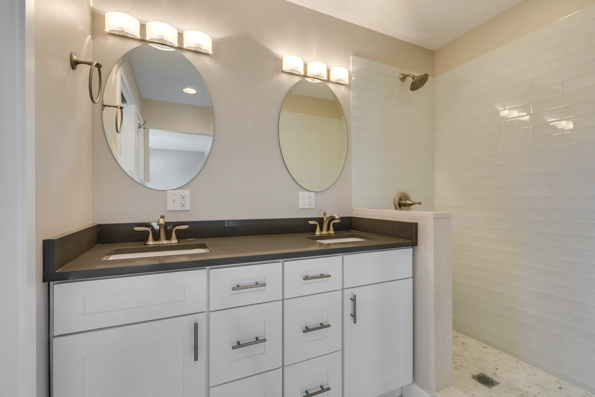 Primary bathroom with double vanity and walk-in shower
